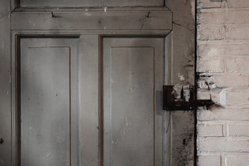 Wall Mural - Old dirty wooden door industrial building dirty, close-up background texture