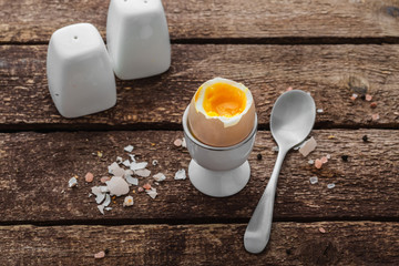 Soft boiled egg on wwoden background, rustic style, copy space