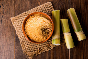 Organic Gur or Jggery Powder is unrefined sugar obtained from concentrated sugarcane juice. served in a bowl. selective focus