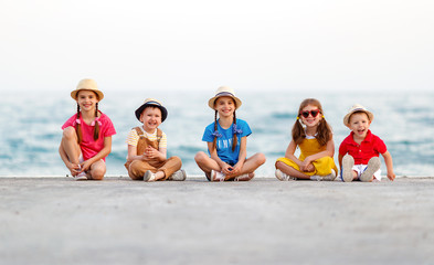 Wall Mural - group of happy children by   sea in summer.