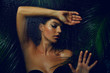 © EkaterinaJurkova - A beautiful, young, tanned girl with wet hair and wet skin is standing in the jungle in the rain.