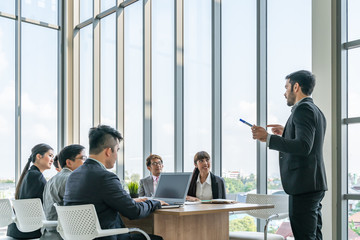 Businesspeople discussing together in conference room during meeting at office.