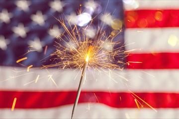 Sparkler and usa flag showing 4th of july