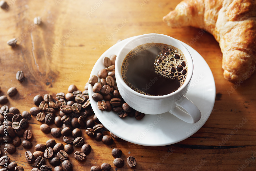 Obraz na płótnie Cup of hot coffee on wooden table w salonie