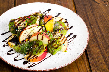 Wall Mural - Fruit dessert from apples, kiwi, chia with chocolate topping