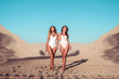 Two girlfriends woman, girl sisters, walk summer beach white sand near sea lake. Concept fashion style, new trend, weekend rest in fresh air. Free space. Sunbathing in the city active lifestyle.