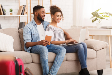 Wall Mural - Planning Vacation. Afro Couple Searching Places On Laptop