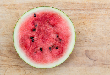 Ripe watermelon on a wooden chopping board