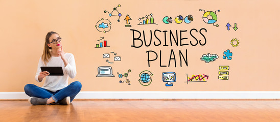 Wall Mural - Business plan with young woman holding a tablet computer