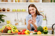 © Prostock-studio - Young Woman Texting when Cooking In Kitchen