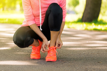 Wall Mural - runner woman tying up laces of shoes