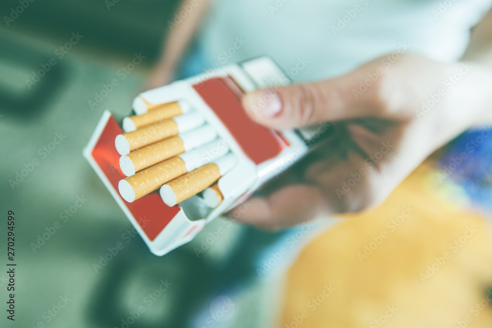 Female hands hold pack of cigarettes , prepare for smoking cigarette Stock  Photo