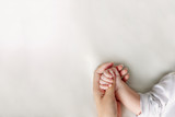 Hands of mother and baby closeup with copy space
