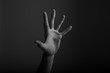 © ink drop - Male open hand gesture on a dark background