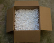 © photomaticstudio - cardboard box with packing foam pellets white polystyrene foam, styrofoam popcorn or packing noodles used to cushion the contents of packages while shipping commonly made of expanded polystyrene foam