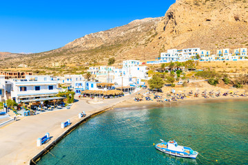 Wall Mural - Fishing boat in picturesque Finiki port with mountains in background, Karpathos island, Greece