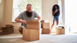 interracial couple moving into new house with boyfriend opening box