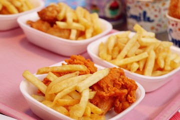 Canvas Print - French fries and fried chicken at market