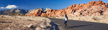 Fit African American Woman Riding Bicycle On Road In Red Rock Canyon Park Panorama