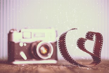 Wall Mural - Blurred Old vintage camera on wooden background