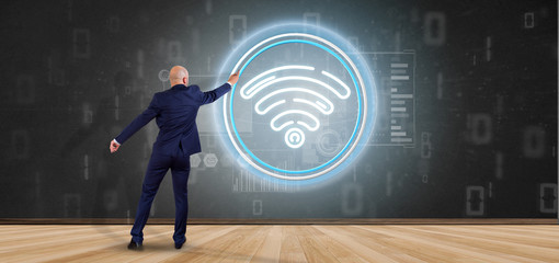 Poster - Businessman in front of a wall with Wifi icon with stats and binary code 3d rendering