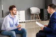 © Pixel-Shot - Human resources manager interviewing man in office