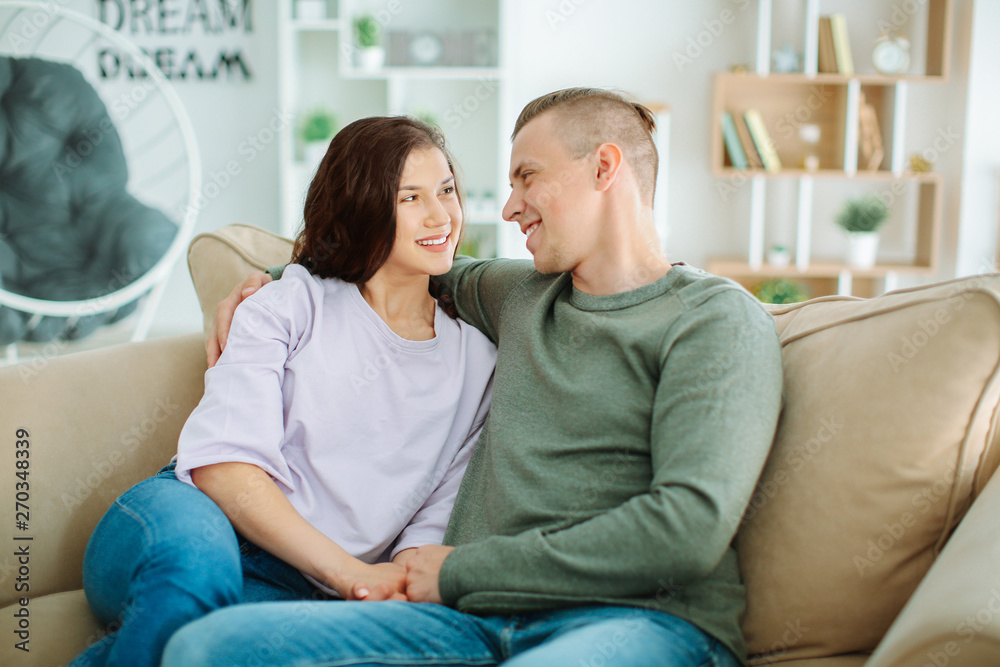 Adorable loving couple resting at home