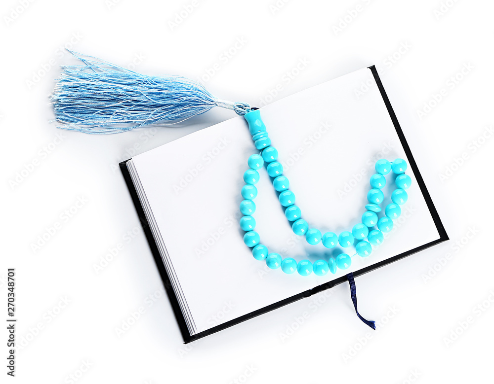 Muslim beads and Koran on white background