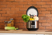 Modern Multi Cooker With Vegetables On Kitchen Table