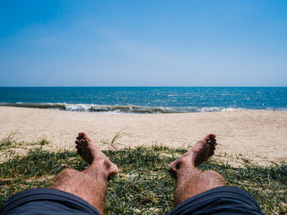 Wall Mural - sunbathing man on the sandy beach
