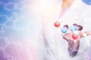 Wall Mural - Close up of Molecular structure model in hand on background