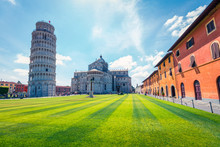 Beautiful Spring View Of Famous Leaning Tower In Pisa. Sunny Morning Scene With Hundreds Of Tourists In Piazza Dei Miracoli (Square Of Miracles), Italy, Europe. Traveling Concept Background.