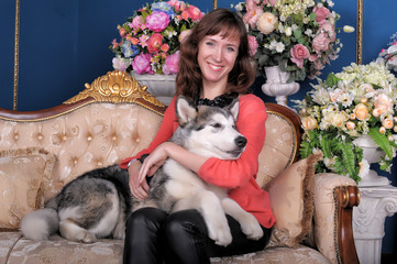 Woman with a puppy Malamute. Happy, adorable.