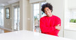 © Krakenimages.com - African American man wearing casual red sweatshirt happy face smiling with crossed arms looking at the camera. Positive person.
