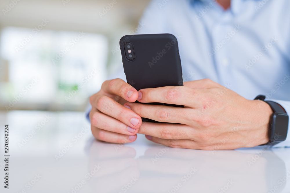 Close up of man hands using smartphone and smiling