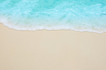 Soft waves of blue sea on the Maldives beach for the background.