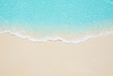 Soft waves of blue sea on the Maldives beach for the background.