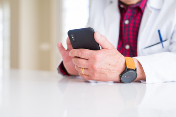 Sticker - Close up of doctor hands using smartphone at the clinic