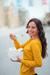 © bnenin - Girl eating takeout lunch in the city, smiling at camera.