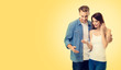 © vgstudio - Photo of young couple, finding out results of a pregnancy test, against yellow color background