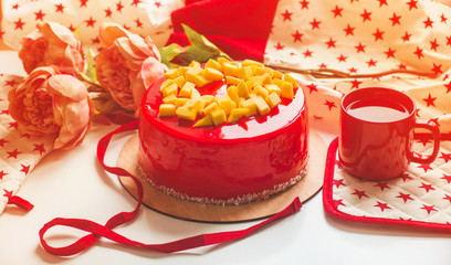 Birthday cake with one candle and red frosting. National bakery. Round cake with mango.