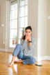 © Krakenimages.com - Young beautiful woman sitting on the floor at home shocked covering mouth with hands for mistake. Secret concept.
