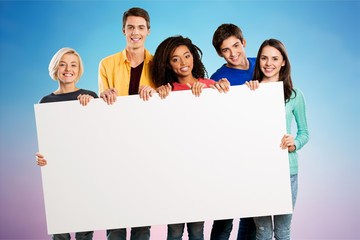 Wall Mural - Group of teens holding blank banner