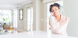 © Krakenimages.com - Wide angle of beautiful african american woman with afro hair Hugging oneself happy and positive, smiling confident. Self love and self care