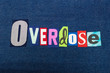 OVERDOSE text word collage, colorful fabric on blue denim, addiction and abuse concept, horizontal aspect
