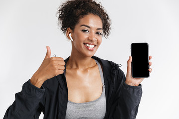 Wall Mural - Young amazing sports fitness african woman using mobile phone listening music.