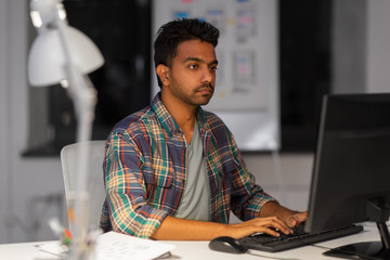Wall Mural - deadline, technology and people concept - creative man with computer working at night office