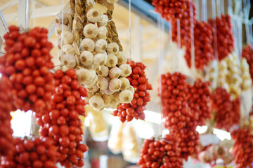 Bunches of organic garlic and cherry tomatoes sold on a marketplace in Genoa, Italy