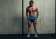 © chrisgraphics - Young strong man posing and flexing his quadriceps legs muscles