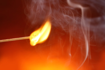 Burning matchstick on color background, closeup. Space for text